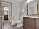 Modern bathroom with wood-style floors and open door leading to adjacent bathroom and shower at 4 & 5 Northlake Cir, Peachtree City, GA 30269