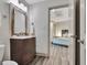 Modern bathroom with wood-style floors and open door leading to bedroom at 4 & 5 Northlake Cir, Peachtree City, GA 30269