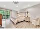 Bright and airy bedroom with hardwood floors, balcony access, and neutral decor at 4 & 5 Northlake Cir, Peachtree City, GA 30269