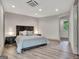 This is a brightly lit bedroom with light gray wood floors, ceiling AC, and light decor at 4 & 5 Northlake Cir, Peachtree City, GA 30269