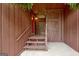 Covered entryway with stairs, decorative lattice, and a red door at 4 & 5 Northlake Cir, Peachtree City, GA 30269