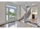 Inviting foyer with large front door, staircase, and adjacent kitchen area at 4 & 5 Northlake Cir, Peachtree City, GA 30269