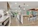 Open concept kitchen with stainless steel appliances, island seating, and a view to the living room at 4 & 5 Northlake Cir, Peachtree City, GA 30269