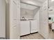 Convenient laundry room with side by side washer and dryer and wire shelving for storage at 4 & 5 Northlake Cir, Peachtree City, GA 30269