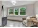 Bright and airy living room with recessed lights, wood-style floors, and large windows with natural light at 4 & 5 Northlake Cir, Peachtree City, GA 30269