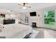 Spacious main bedroom featuring a fireplace, mounted TV, and large windows with a backyard view at 4 & 5 Northlake Cir, Peachtree City, GA 30269