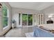 Bright main bedroom boasts a private balcony, stylish decor, and a large window showcasing lush greenery at 4 & 5 Northlake Cir, Peachtree City, GA 30269