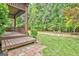 Covered back patio with a view of the manicured backyard, landscaping and rock features at 4 & 5 Northlake Cir, Peachtree City, GA 30269