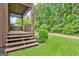 View of the porch with steps that lead to a green lawn and the backyard area at 4 & 5 Northlake Cir, Peachtree City, GA 30269