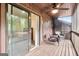 Outdoor screened-in porch with hardwood flooring and wicker chairs with blue cushions at 4 & 5 Northlake Cir, Peachtree City, GA 30269