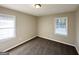 Cozy bedroom featuring carpeted floors and natural light provided by two windows at 4267 Lamar St, Decatur, GA 30035