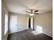 Bright bedroom featuring carpeted floors, ceiling fan with light, and an attached bathroom at 4267 Lamar St, Decatur, GA 30035