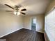 Bedroom featuring wood floors, ceiling fan with light, and a view to another room at 4267 Lamar St, Decatur, GA 30035