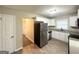 Well-lit kitchen featuring stainless steel appliances, granite countertops and bright cabinetry at 4267 Lamar St, Decatur, GA 30035