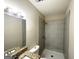 Bathroom featuring modern shower with tiled walls and a vanity with granite countertops at 2017 Lindsey Ln, Decatur, GA 30035