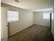 Neutral bedroom featuring carpet flooring and two windows with blinds at 2017 Lindsey Ln, Decatur, GA 30035