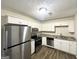 Modern kitchen featuring stainless steel appliances, granite countertops, and ample cabinet space at 2017 Lindsey Ln, Decatur, GA 30035