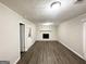 Finished basement area with wood-look floors and a brick fireplace at 2317 Emerald Springs Dr, Decatur, GA 30035