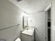 Well-lit bathroom featuring a granite countertop, framed mirror, and convenient towel rack at 2317 Emerald Springs Dr, Decatur, GA 30035