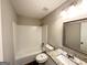 Well-lit bathroom with granite countertop, framed mirror, and tiled shower/tub combination at 2317 Emerald Springs Dr, Decatur, GA 30035