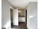 Hallway view into bathroom, with granite countertops and white cabinetry at 2317 Emerald Springs Dr, Decatur, GA 30035