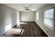 Bright living room with new flooring, ceiling fan, and windows providing ample natural light at 2317 Emerald Springs Dr, Decatur, GA 30035