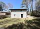Backyard view of the home featuring a brick facade and nice landscaping at 2676 Stone Rd, East Point, GA 30344