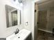 Bathroom with glass-enclosed shower featuring tile, vanity, and a mirror at 2676 Stone Rd, East Point, GA 30344
