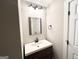 Bathroom with a modern vanity, framed mirror and a three light fixture at 2676 Stone Rd, East Point, GA 30344