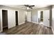 Bedroom with wood-look flooring, ceiling fan, closet, and bathroom access at 2676 Stone Rd, East Point, GA 30344