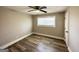 Comfortable bedroom with hardwood floors, a ceiling fan, and a bright window at 2676 Stone Rd, East Point, GA 30344