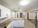 Spacious kitchen with a butcher block island, stainless steel appliances, and tile flooring at 2676 Stone Rd, East Point, GA 30344