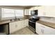 Well-lit kitchen featuring updated stainless steel appliances and butcher block countertops at 2676 Stone Rd, East Point, GA 30344