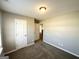 Bedroom featuring neutral walls and carpet, showing closet and hallway entrances at 315 Breezy Hill Walk, Stockbridge, GA 30281