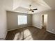 Comfortable main bedroom featuring a ceiling fan, carpet, and a tray ceiling at 315 Breezy Hill Walk, Stockbridge, GA 30281