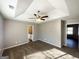 Bright main bedroom boasts a ceiling fan, tray ceilings, carpet, and ensuite bathroom at 315 Breezy Hill Walk, Stockbridge, GA 30281
