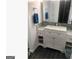 Bathroom with marble countertop, large mirror, white wooden cabinets, and modern fixtures at 3834 Kensingwood Trce, Decatur, GA 30032