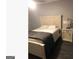 Comfortable bedroom with neutral walls, a cozy bed, and a modern nightstand at 3834 Kensingwood Trce, Decatur, GA 30032