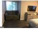 Bedroom featuring modern finishes, hardwood floors, seating area, and flatscreen television at 3834 Kensingwood Trce, Decatur, GA 30032