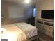 Cozy bedroom with light-colored walls, a bed, a dresser, and natural light at 3834 Kensingwood Trce, Decatur, GA 30032
