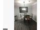 Traditional dining room featuring a glass-top table, wood-look flooring, and modern lighting fixture at 3834 Kensingwood Trce, Decatur, GA 30032
