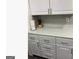 Kitchen featuring white cabinets with modern hardware and a stylish backsplash at 3834 Kensingwood Trce, Decatur, GA 30032