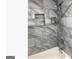 Stylish shower features gray marble-style tiles, a shower niche, and modern fixtures at 3834 Kensingwood Trce, Decatur, GA 30032