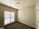 Cozy bedroom with neutral walls, plush carpet, and a bright window creating a serene and comfortable space at 710 Thomasville Se Blvd, Atlanta, GA 30315