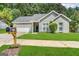 Charming single-story home with manicured lawn and a well-maintained exterior and a convenient attached garage at 710 Thomasville Se Blvd, Atlanta, GA 30315