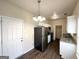 Eat-in kitchen with stainless steel refrigerator, tile countertops, and white cabinets for a modern touch at 710 Thomasville Se Blvd, Atlanta, GA 30315
