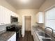 Galley kitchen with granite countertops, stainless steel appliances, and white cabinets, offering modern functionality at 710 Thomasville Se Blvd, Atlanta, GA 30315