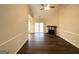 Spacious living room featuring dark wood-look flooring, ceiling fan, and a fireplace for a warm ambiance at 710 Thomasville Se Blvd, Atlanta, GA 30315