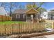 Charming home with a wooden fence surrounding the front yard at 1101 Oak Knoll Ter, Atlanta, GA 30315