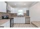 Modern kitchen with white cabinets, butcher block countertops, and stainless steel appliances at 1101 Oak Knoll Ter, Atlanta, GA 30315